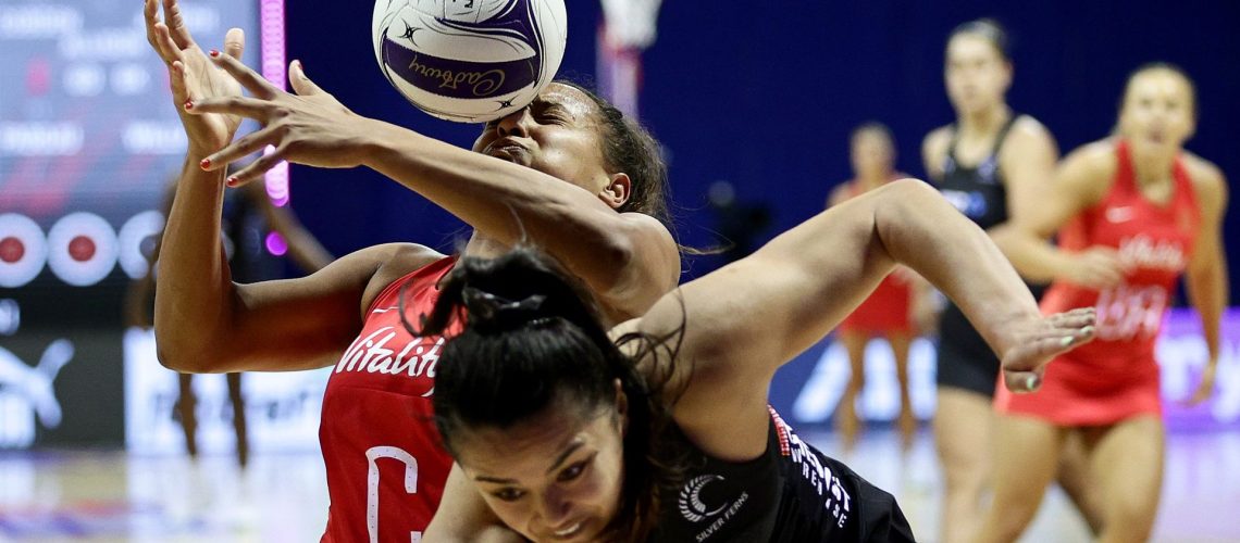 Imogen Allison and Kimiora Poi wrestle for the ball in an England vs New Zealand netball clash