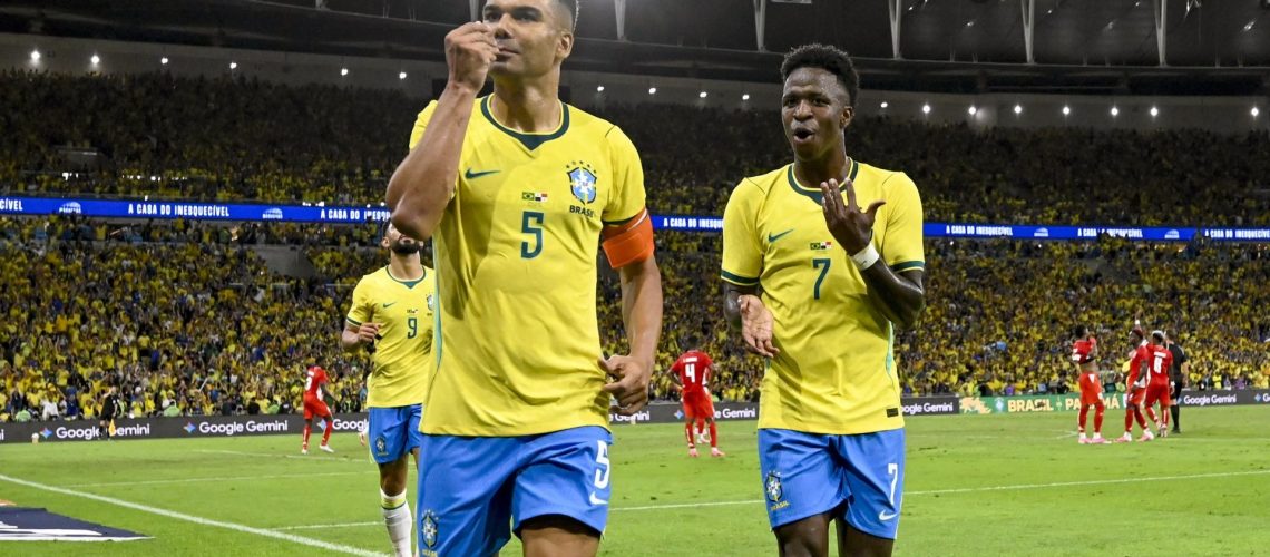 Brazil's Casemiro celebrating with Vinicius Junior