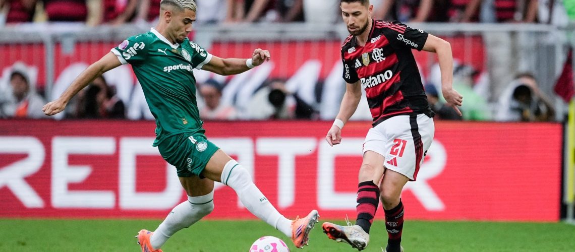Flamengo's Jorginho passing the ball under pressure from Palmeiras' Andreas Pereira ahead of the 2025 Copa Libertadores final