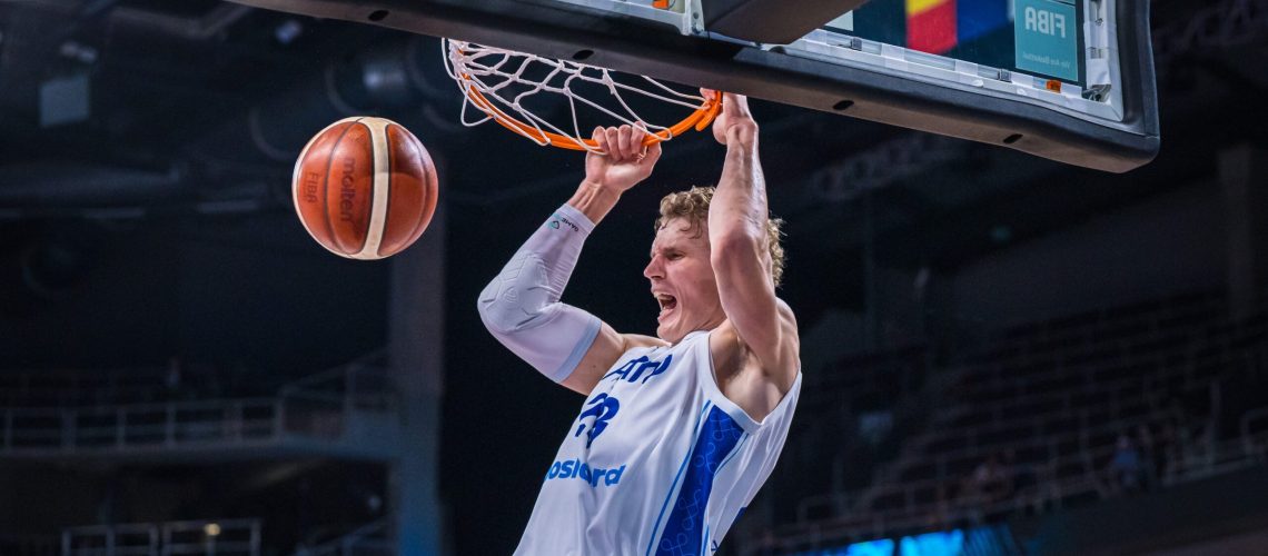 Lauri Markkanen of Finland hangs on the rim in celebration after a thunderous dunk during the FIBA EuroBasket 2025 quarterfinal between Finland and Georgia at Arena Riga on September 10, 2025 in Riga, Latvia.