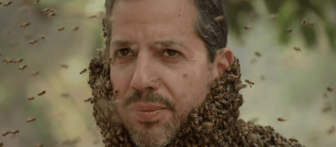 Magician David Blaine covered in bees in a scene from his new TV series, David Blaine: Do Not Attempt 2025
