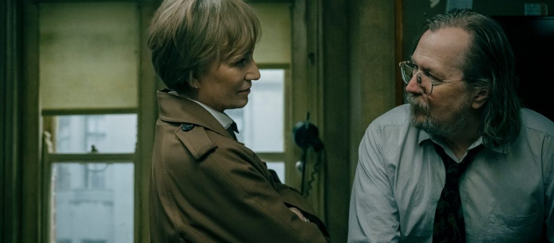 MI5 deputy director Diana Taverner (Kristin Scott Thomas) delivers some unwelcome news to unkempt agent Jackson Lamb in the dingy office interior of Slough House in Slow Horses season 5.