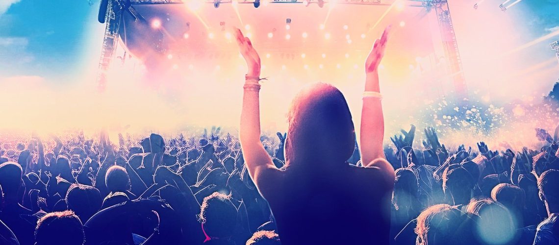 Promotional image of crowd of music fans cheering for "Isle of Wight Festival 2026"
