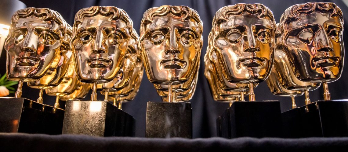 BAFTA Film Awards statues lined up in a row.