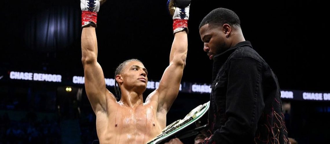 Misfits boxer Chase DeMoor raises his arms aloft after defending his Misfits boxing heavyweight title.