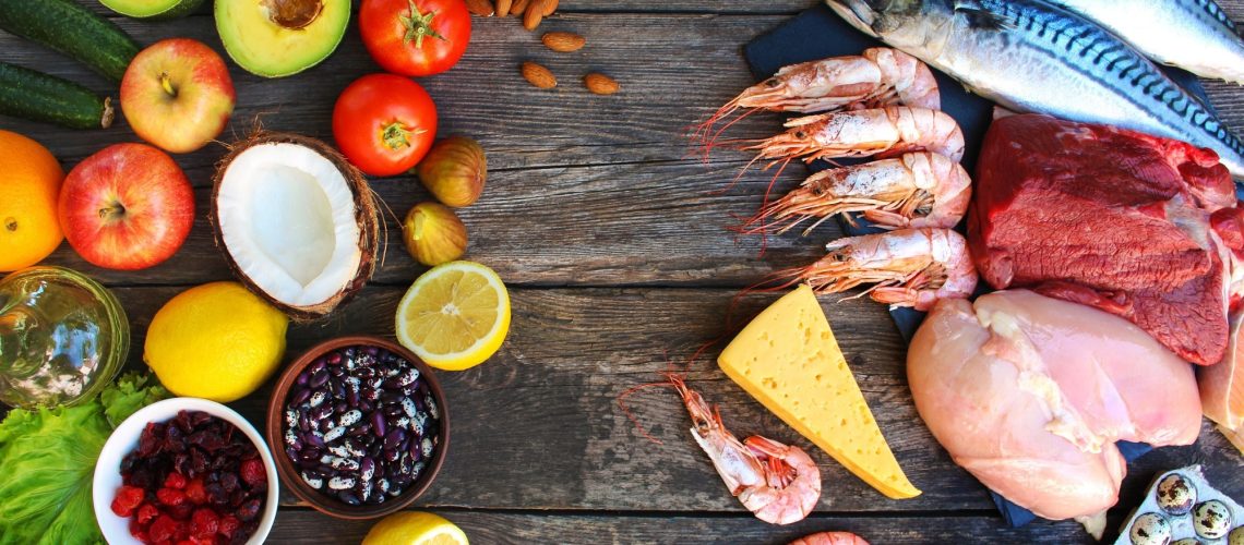 Healthy food of animal and vegetable origin on old wooden background.