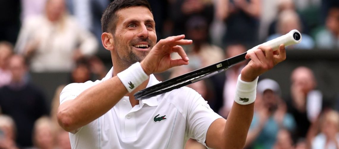 Novak Djokovic of Serbia mimes playing his tennis racquet like a violin to antagonize the All England Club crowd ahead of the Alcaraz vs Djokovic Wimbledon final 2024
