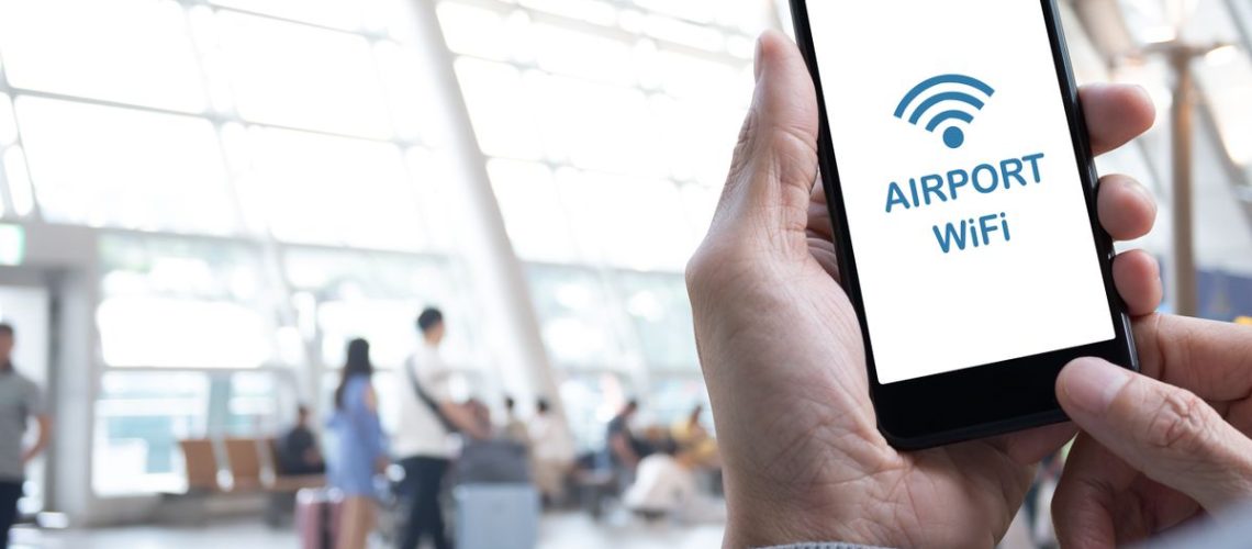 person on Airport free Wi-Fi using a phone