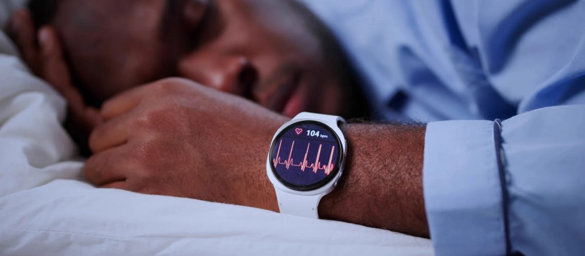 Man Asleep Using Smartwatch To Track Sleep Patterns During Night