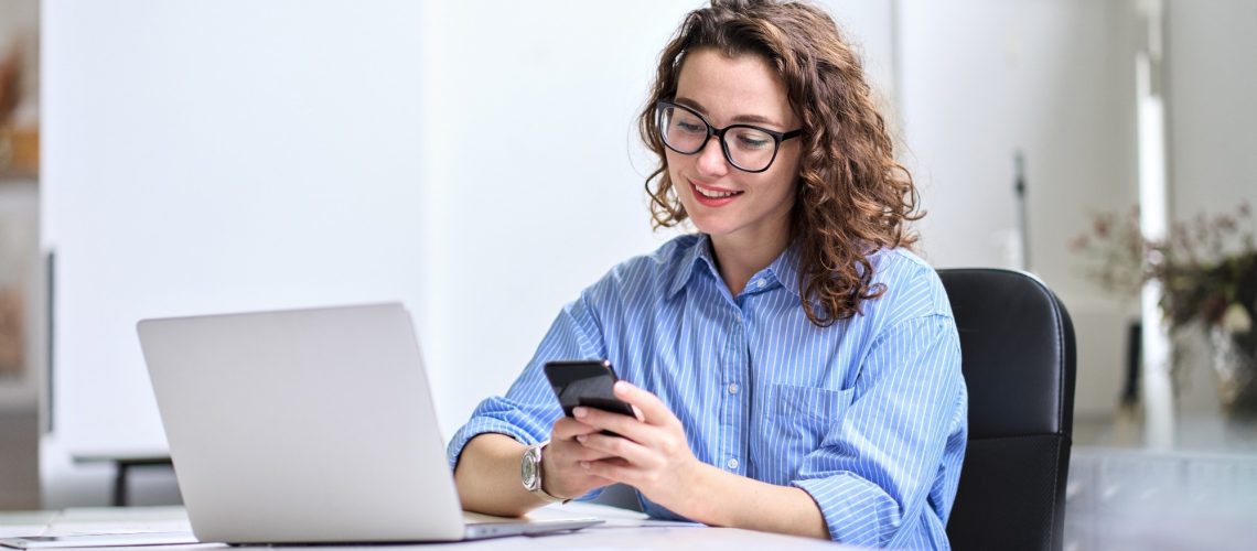 Professional businesswoman worker looking at smartphone