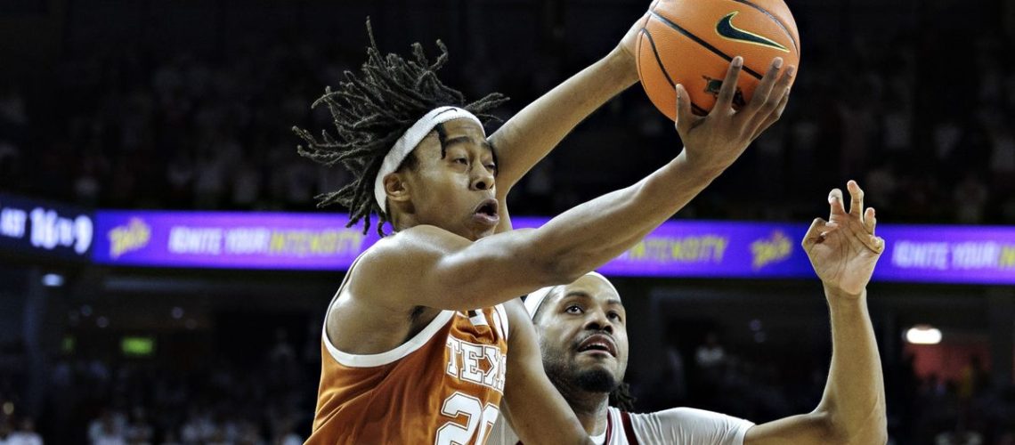 Tre Johnson #20 of the Texas Longhorns drives to the basket in the second half against Jonas Aidoo #9 of the Arkansas Razorbacks at Bud Walton Arena ahead of March Madness 2025 LIVE (Photo by Wesley Hitt/Getty Images)