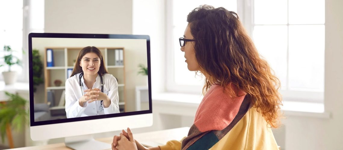Sick woman listening recommendations and appointment having online video call with a female friendly smiling doctor using pc computer at home.