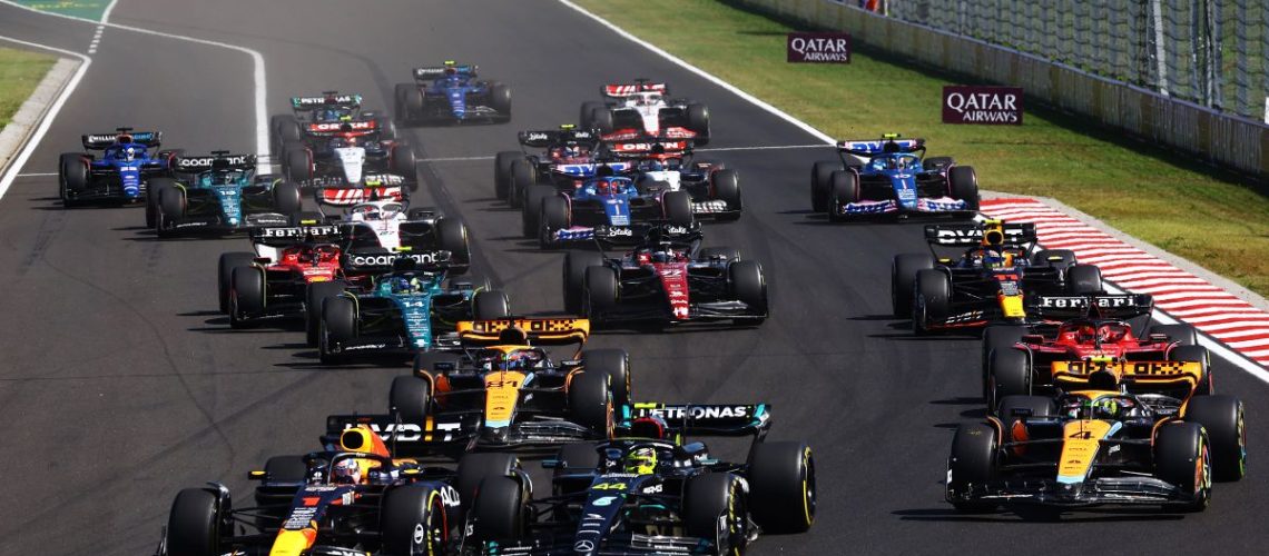Max Verstappen of the Netherlands driving the (1) Oracle Red Bull Racing RB19 leads the pack through the first corner at the F1 Hungarian Grand Prix.