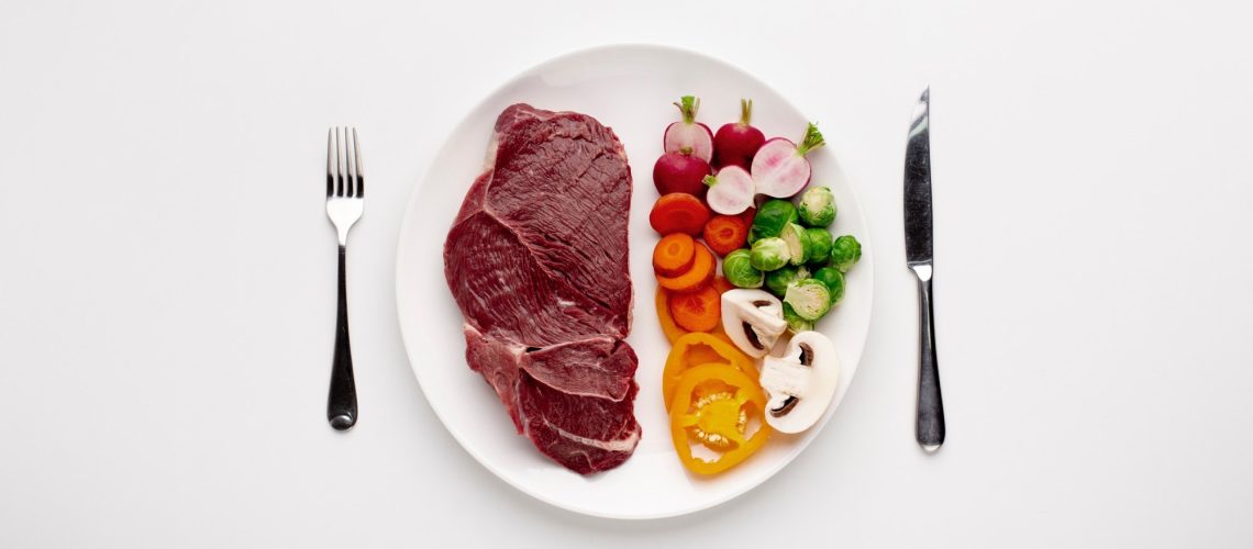 Served plate with meat and vegetables, top view