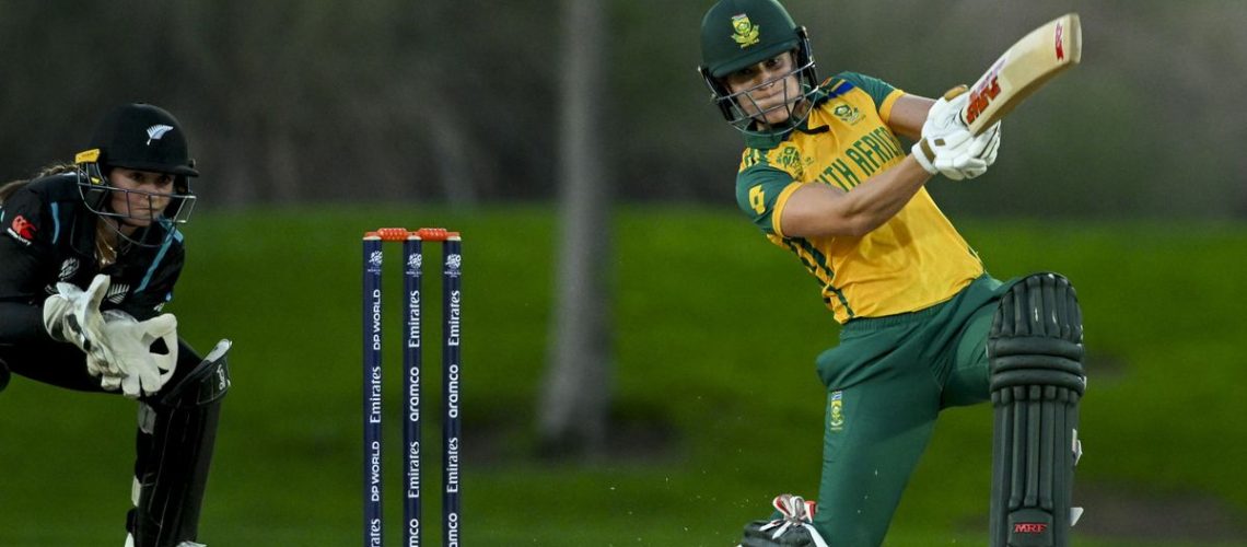 Anneke Bosch of South Africa takes a swing at the ball with the New Zealand wicket keeper just behind, during a women's T20 match.