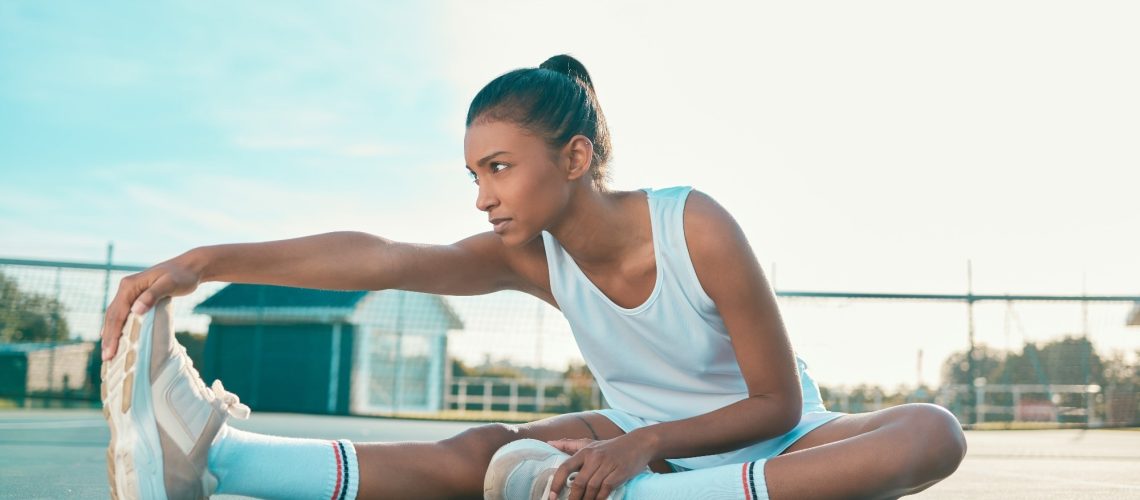 Tennis player, girl and stretching for fitness on court with leg warm up, getting ready and match practice.