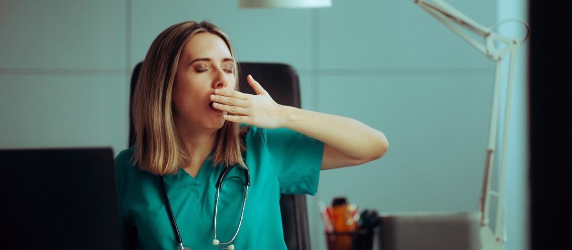 Sleepy medical practitioner working in a night shift