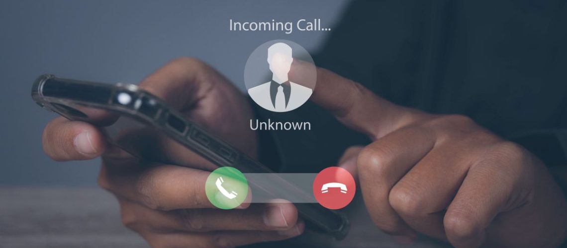 Phone scam showing an unknown caller on a phone screen