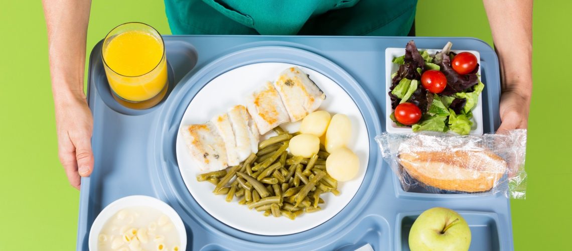 Health professional with a tray of food