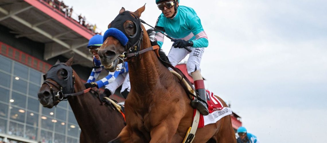 Jockey John Velazquez #1 riding National Treasure (FRONT) rides alongside jockey Irad Ortiz Jr. #7 riding Blazing Sevens to cross the finish line first to win the 148th Running of the Preakness Stakes