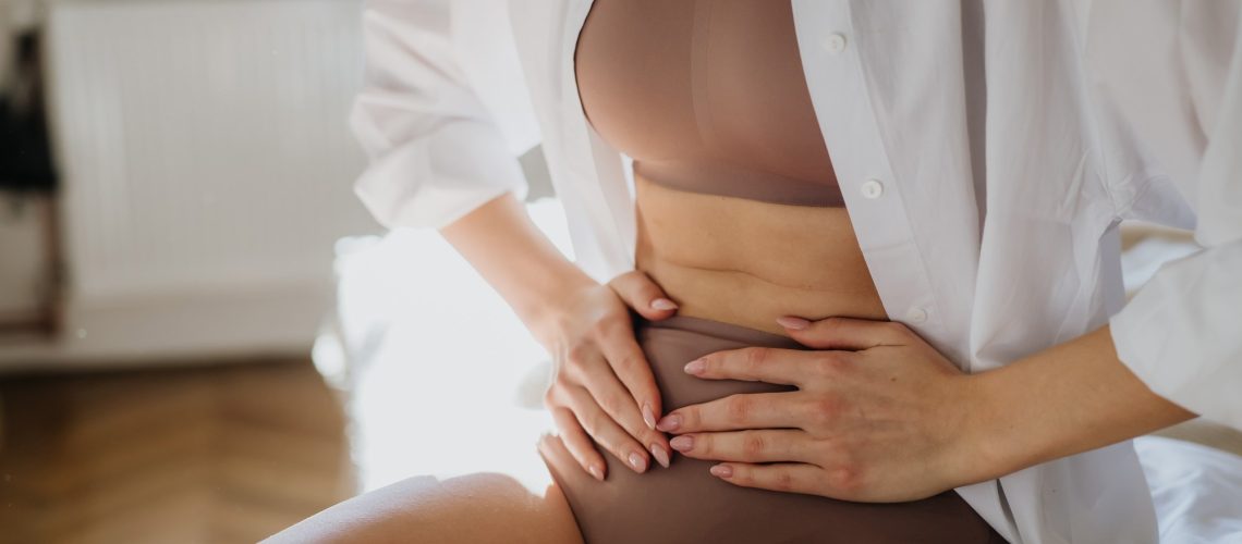 Woman at home suffering from menstrual pain, having cramps.