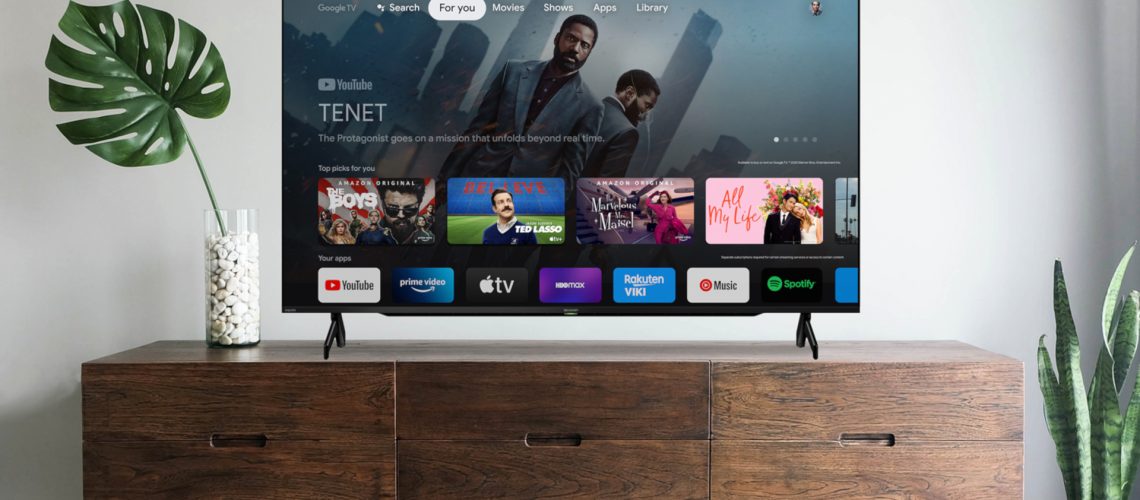 Google TV OS on TV on stand in living room