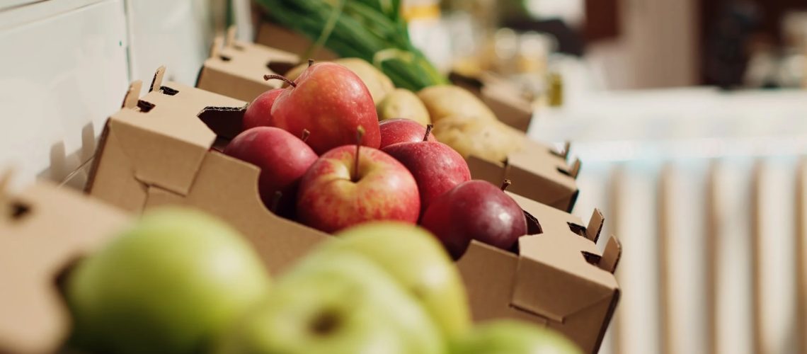 Close up zoom out shot of organic fruits and vegetables on farmers market shelves. Freshly harvested chemicals free food items in environmentally friendly zero waste supermarket