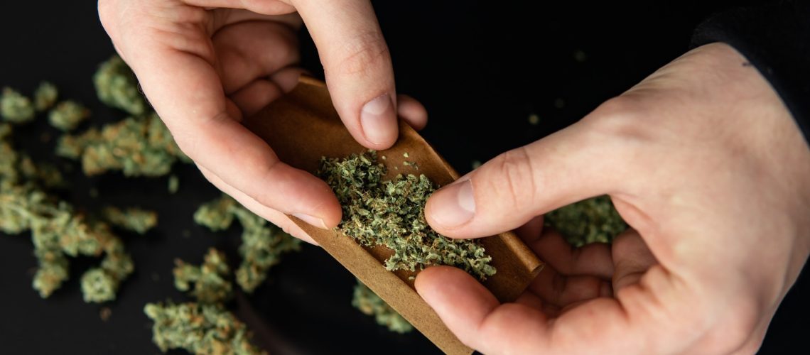 Man rolling a marijuana joint