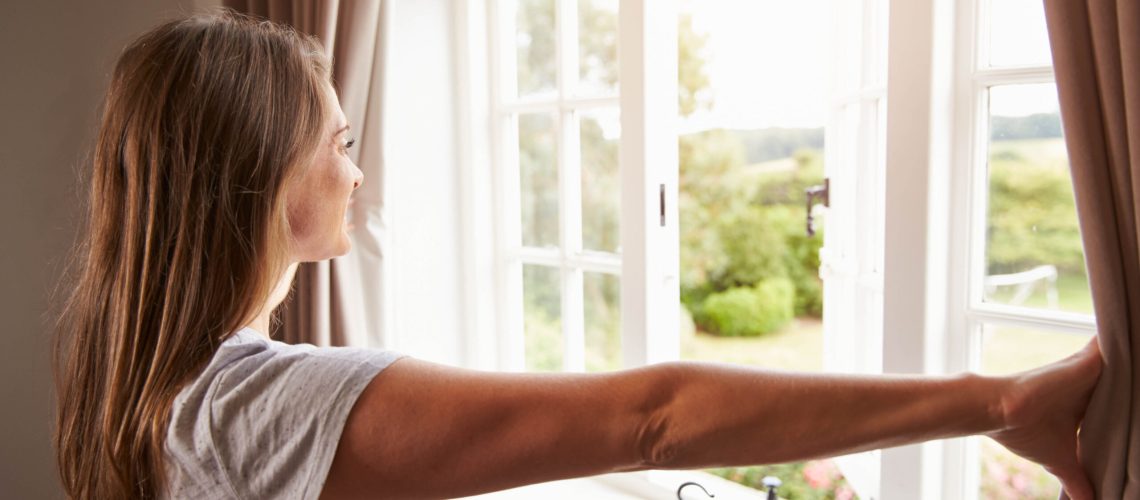 Woman opening a window