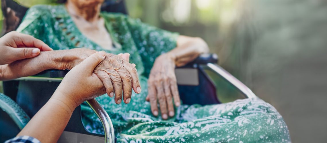 Elderly asian woman on wheelchair at home with daughter take care