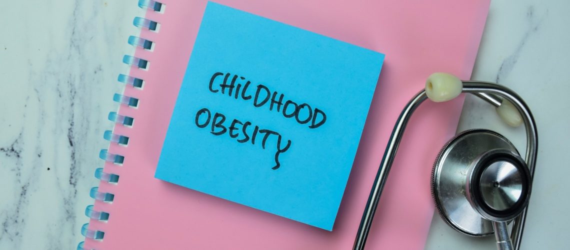 Notebook with sticky note saying childhood obesity