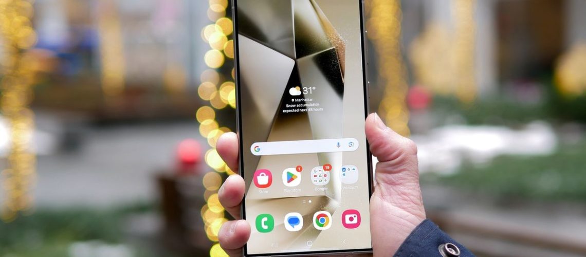 Samsung Galaxy S24 Ultra in hand showing display and home screen