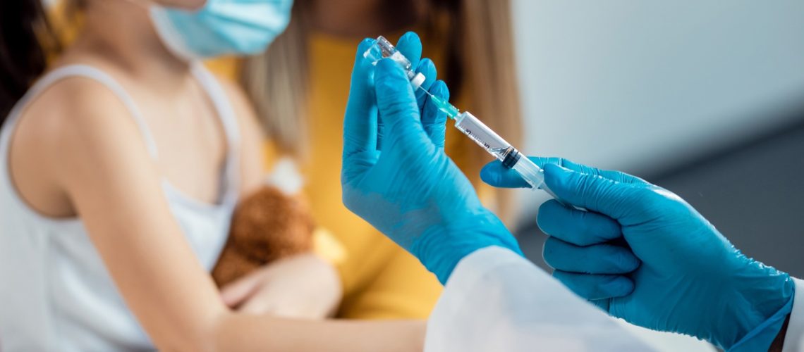 Close-up of pediatrician preparing a vaccine