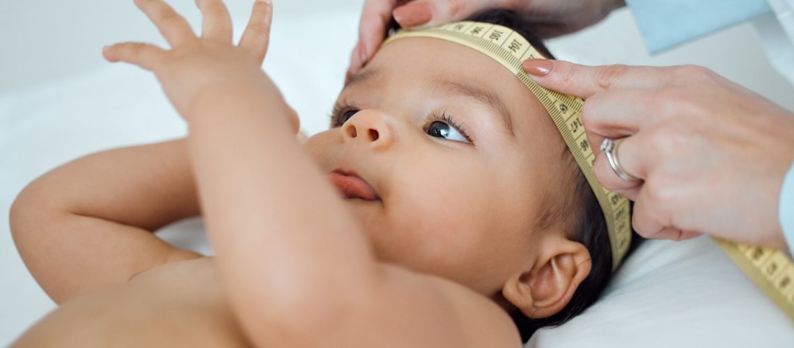 Baby head being measured with a tape measure