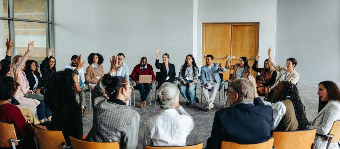 Group of diverse people participating in a support group meeting.