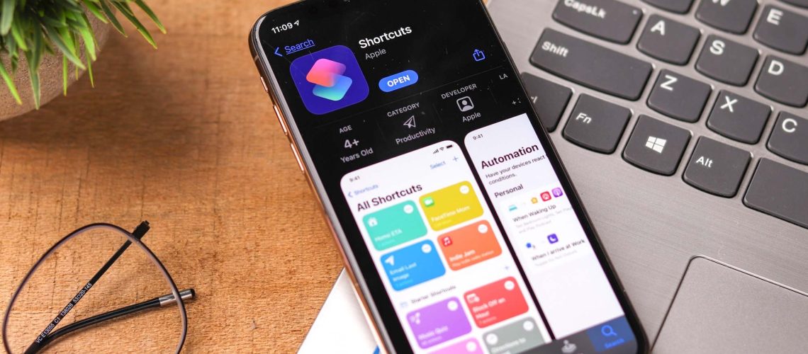 iOS Shortcuts app on iPhone place on top of MacBook