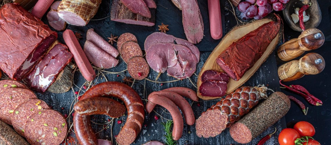 Variety of processed cold red meat products.