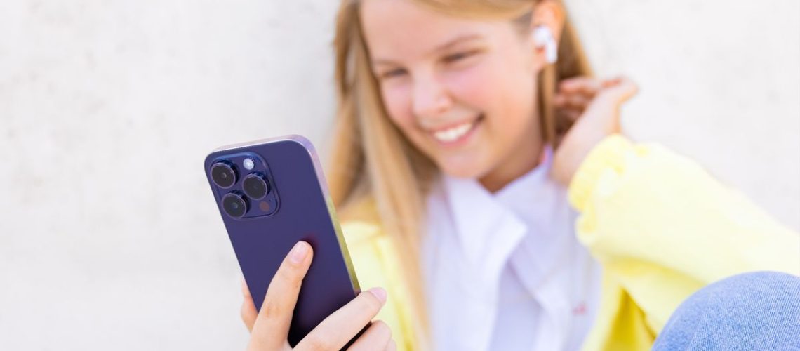 Teenage girl using iPhone
