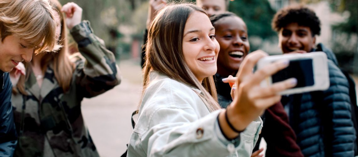 Teenagers taking a selfie while protected by parental controls