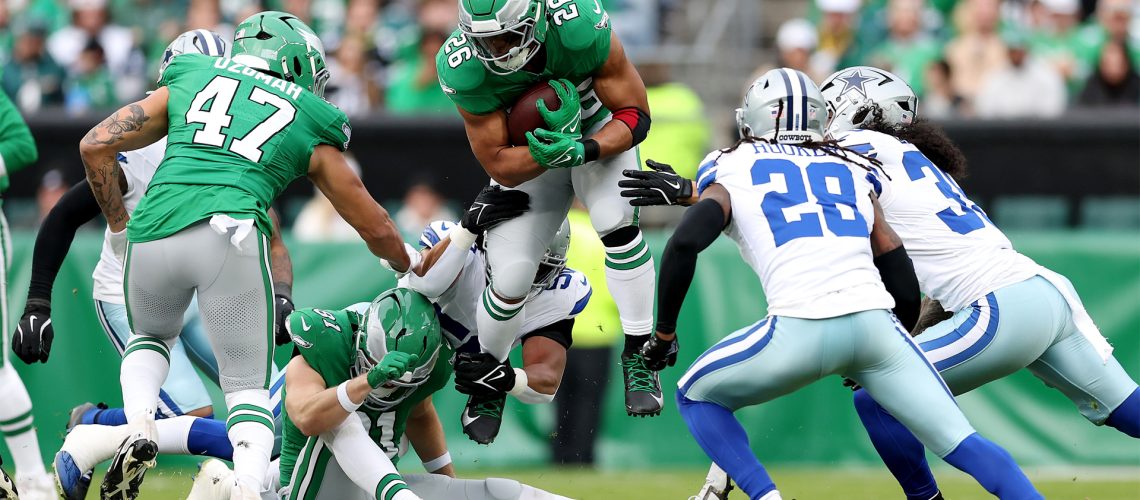 Saquon Barkley of the Philadelphia Eagles carries the ball against the Dallas Cowboys during a December 2024 NFL match.