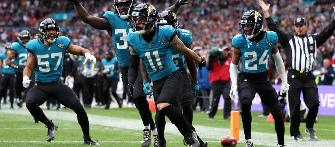 Parker Washington of Jacksonville Jaguars celebrates scoring a touch down with teammates during the NFL match between New England Patriots and Jacksonville Jaguars at Wembley Stadium on October 20, 2024 in London, England.