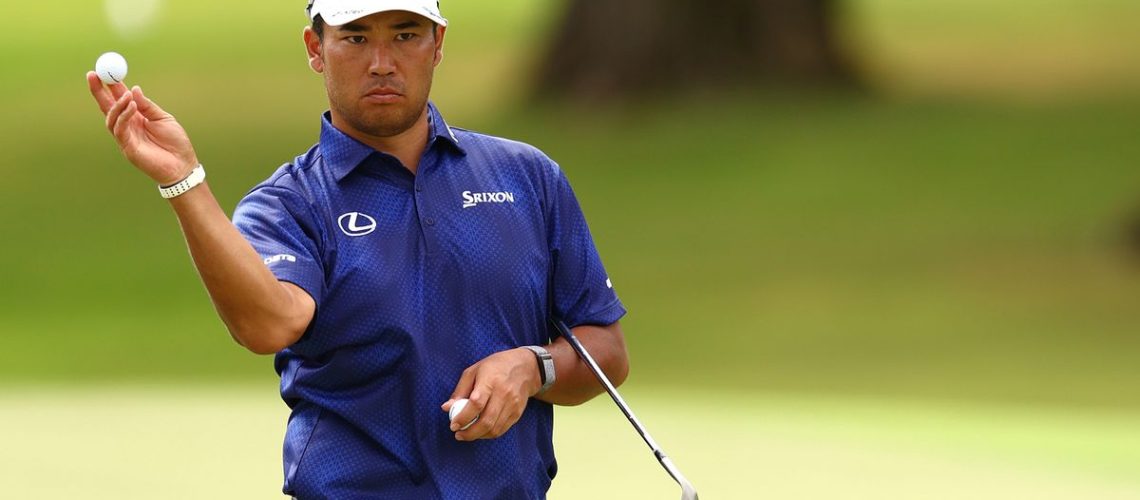 Hideki Matsuyama holds a golf ball on the fairway ahead of the Sony Open 2025 PGA tournament airing live online and on TV around the world.