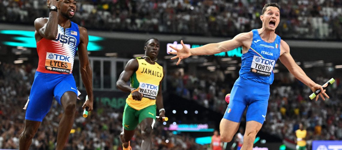 USA's Noah Lyles and Italy's Filippo Tortu react after the men's 4x100m relay final during the World Athletics Championships at the National Athletics Centre in Budapest on August 26, 2023.