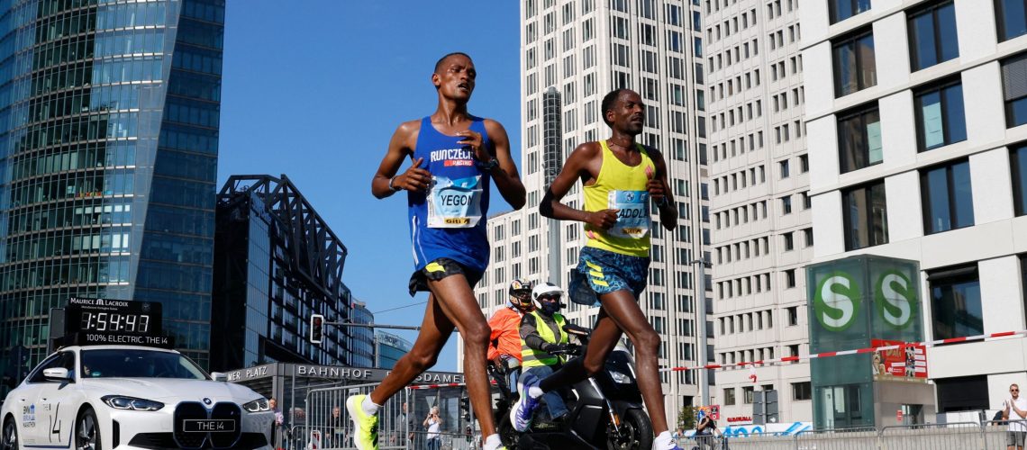 Ethiopia's Guye Adola (R) competes to win ahead of Kenya's Bethwel Yegon (L) during the Berlin Marathon on September 26, 2021 in Berlin.