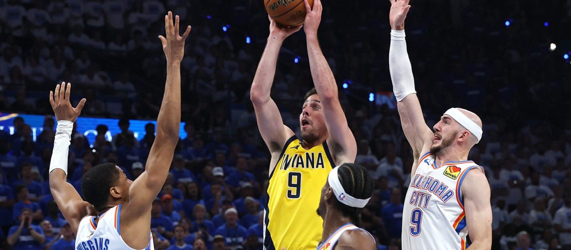 T.J. McConnell #9 of the Indiana Pacers attempts a jump shot against Alex Caruso #9 and Aaron Wiggins #21 of the Oklahoma City Thunder