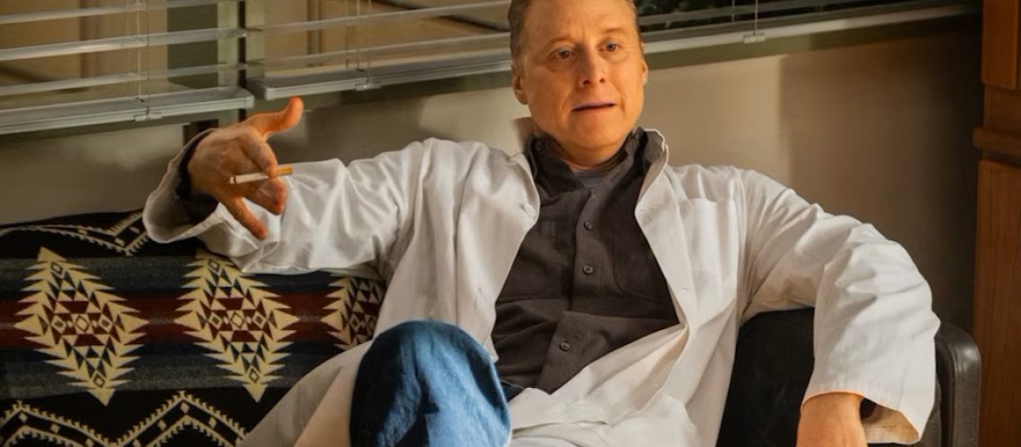 Harry Vanderspeigle (Alan Tudyk) dressed in a doctor's coat and holding a cigarette in &quot;Resident Alien&quot; Season 4 Episode 1.