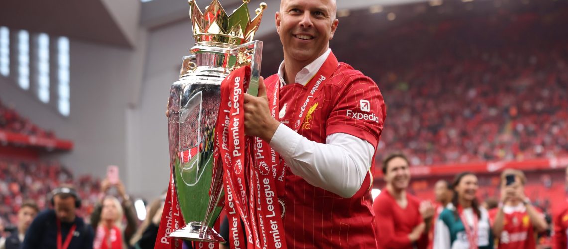Arne Slot, Manager of Liverpool, celebrates with the Premier League trophy, as Liverpool are crowned the Champions of the Premier League for the 2024/25 Season, following the Premier League match between Liverpool FC and Crystal Palace FC at Anfield on May 25, 2025 in Liverpool, England.