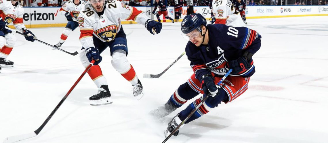 Artemi Panarin #10 of the New York Rangers skates with the puck against Josh Mahura #28 of the Florida Panthers at Madison Square Garden on March 23, 2024 in New York City.