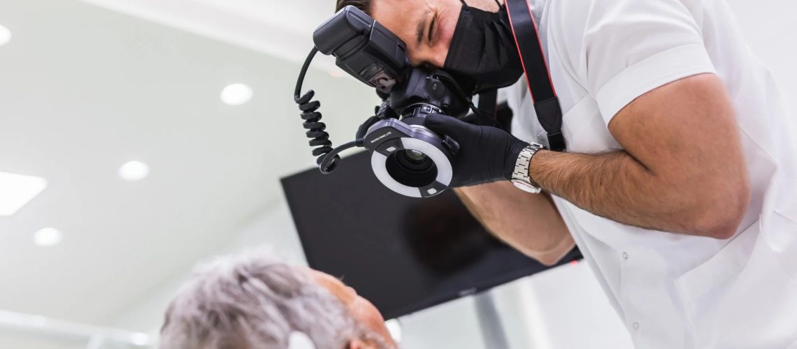 healthcare worker taking photographs of mature patient