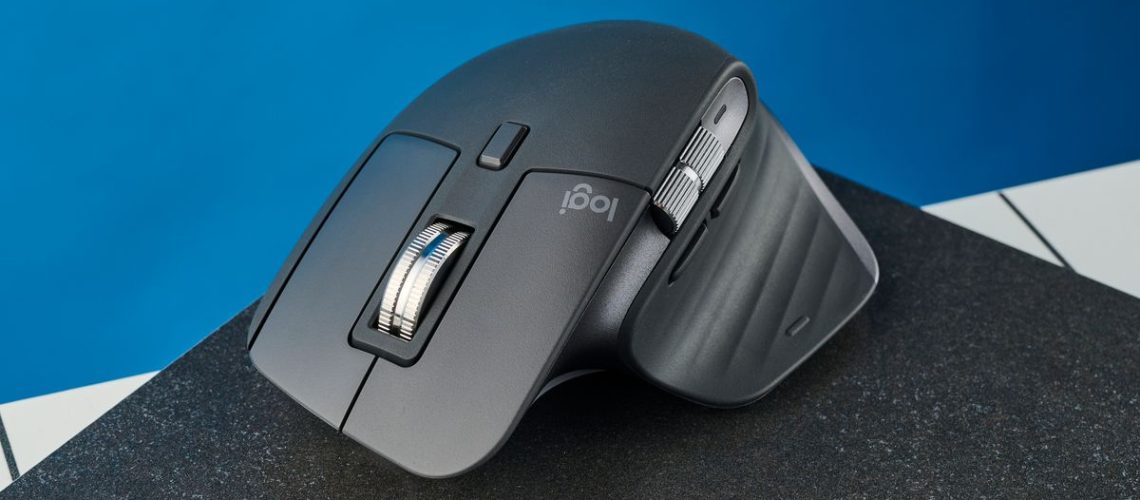 A photo of the Logitech MX Master 3S on a black slate against a blue background.